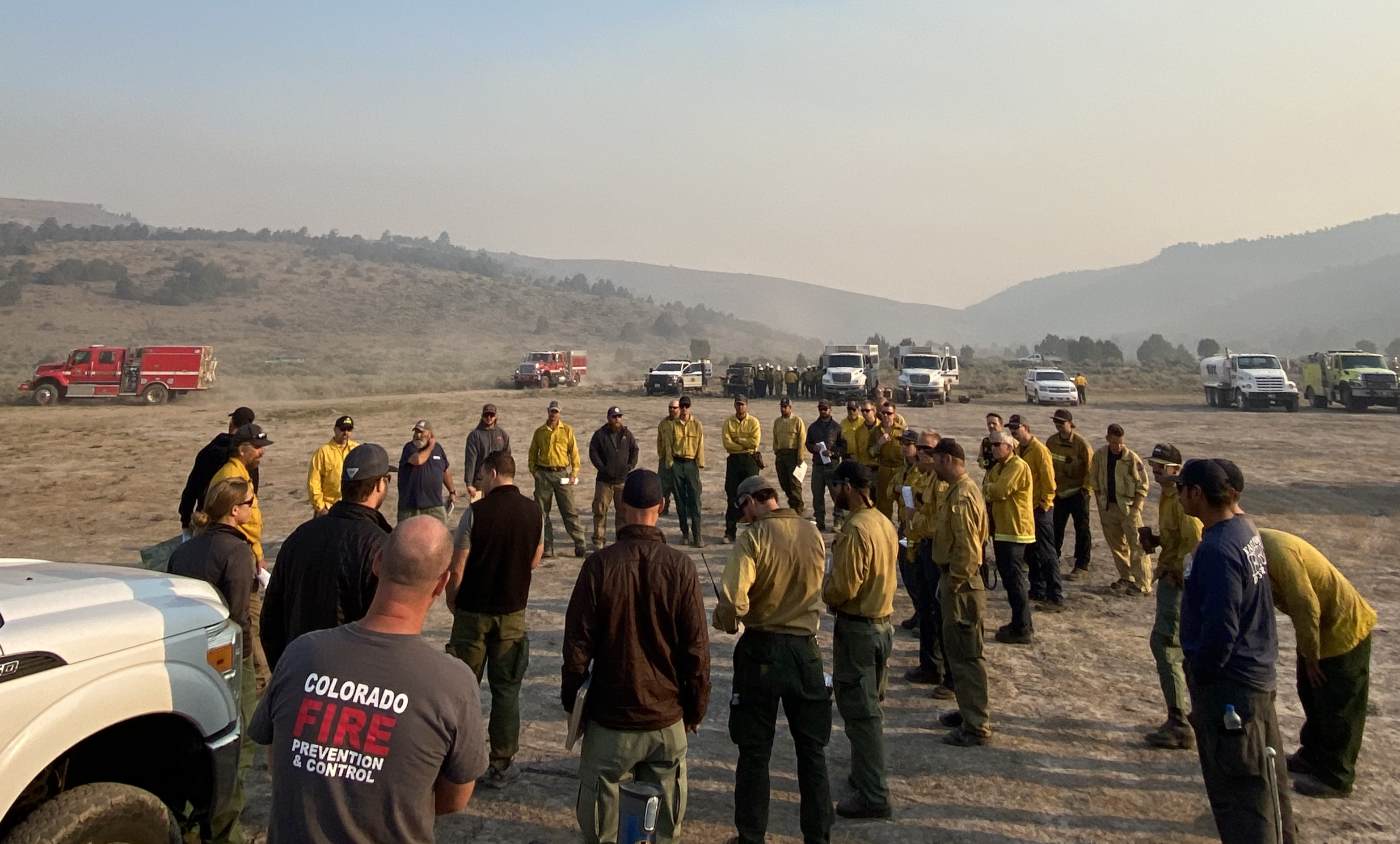 Photo 2 USFS and CoE personnel briefing firefighters on the Tamarack Fire on a technology pilot project July 23 2021